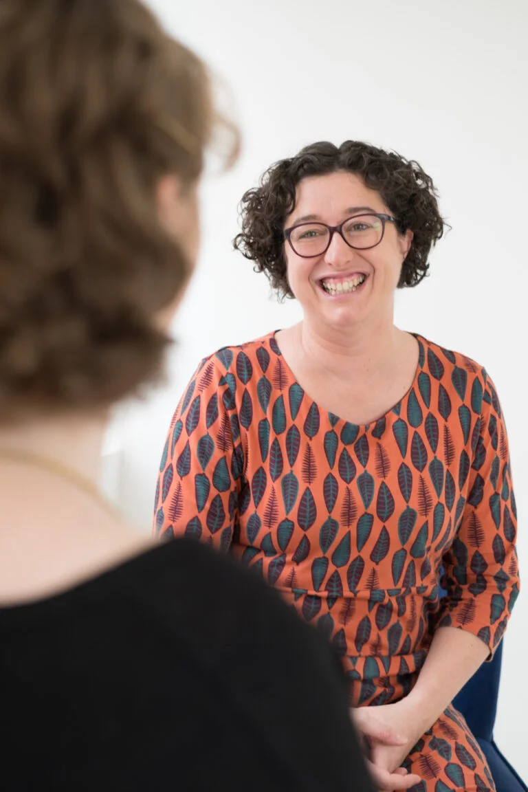 Woman life coach smiling to client