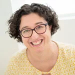 Happiness woman life coach smiling with a yellow T shirt