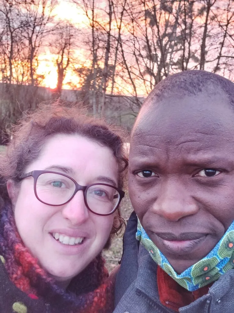 couple white woman and black man wearing masks during covid lockdown with sunset