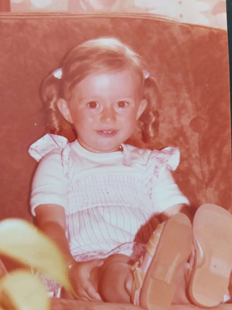 little girl with ADHD with pigtails sitting on a sofa