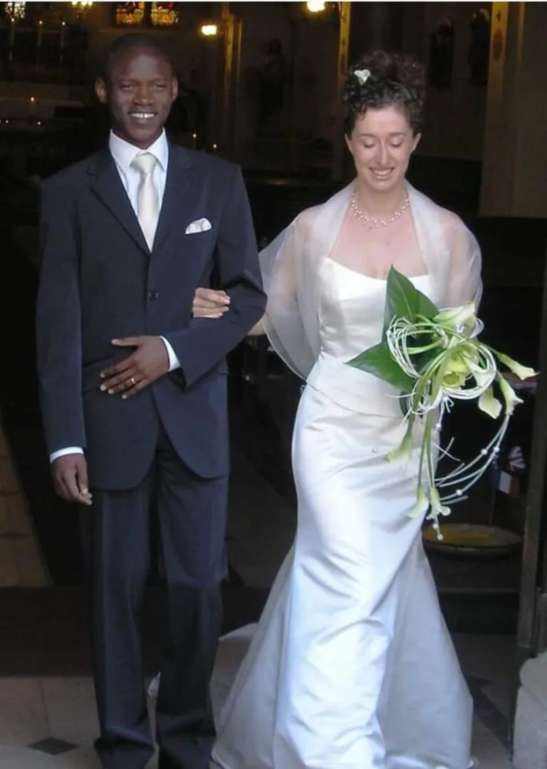 black groom and white bride coming out of church after getting married