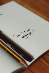 journaling words written on a blank page by a mother saying Am I good enough?