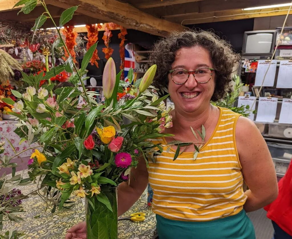 flowers in a bouquet with peggy cheyo woman in yellow smiling