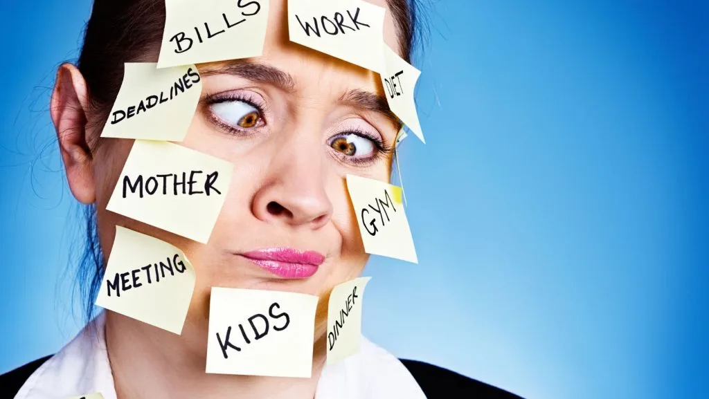woman with post-its on her face with all the things she has to remember: kids, bills, work, mother, cleaner, gym, ...