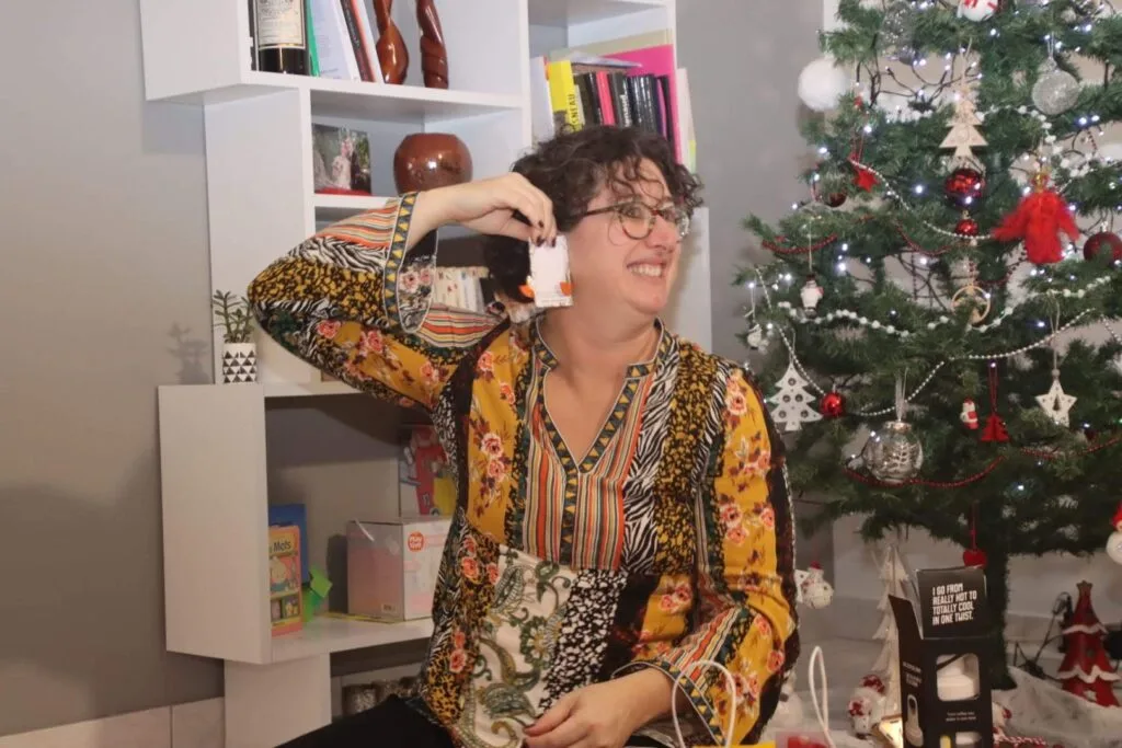 Peggy Cheyo, woman with ADHD is showing off her new earrings she got for Christmas