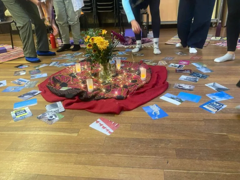 altar with a red cloth and some candles and flowers