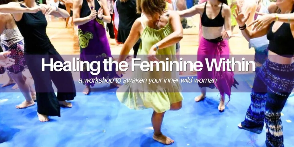 women dancing joyfully together in a Biodanza session on a bright blue floor